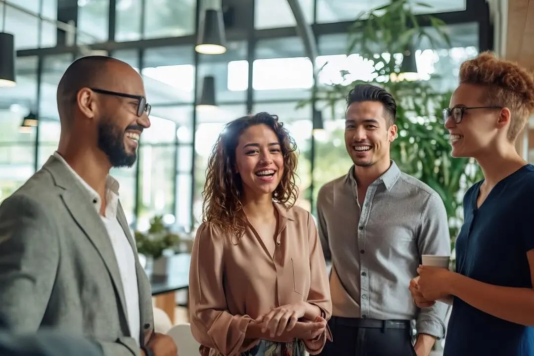 UK_Web_Desktop-A group of people standing around talking to each other
